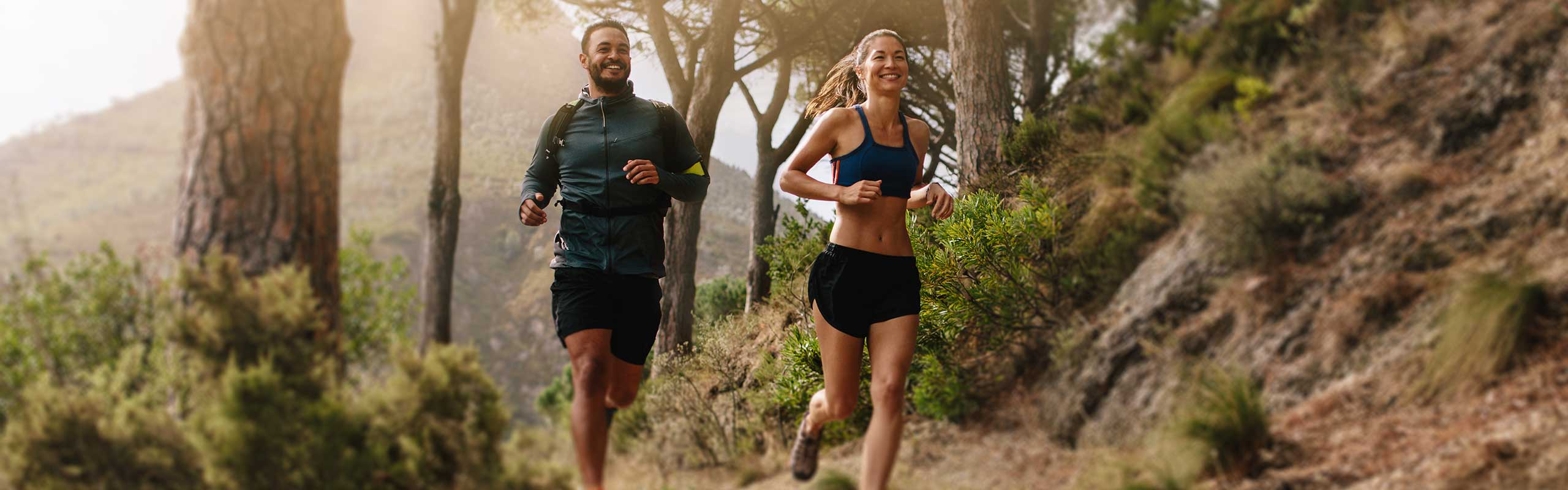 Couple jogging on a forest trail