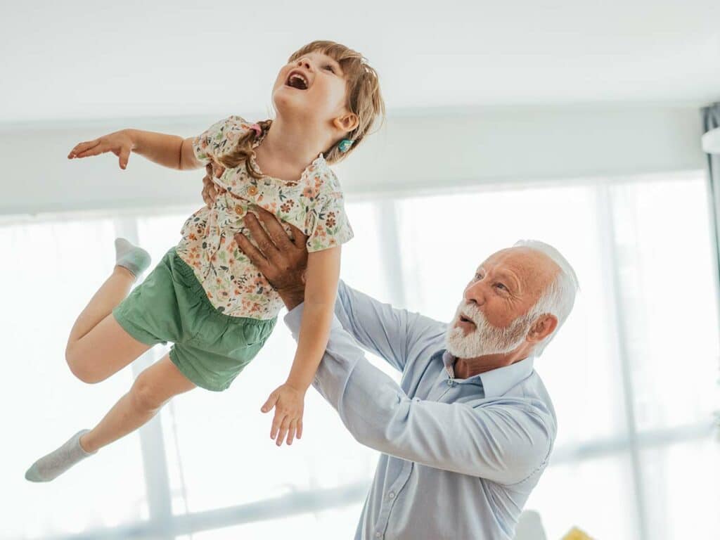 Old man lifting up his grandson